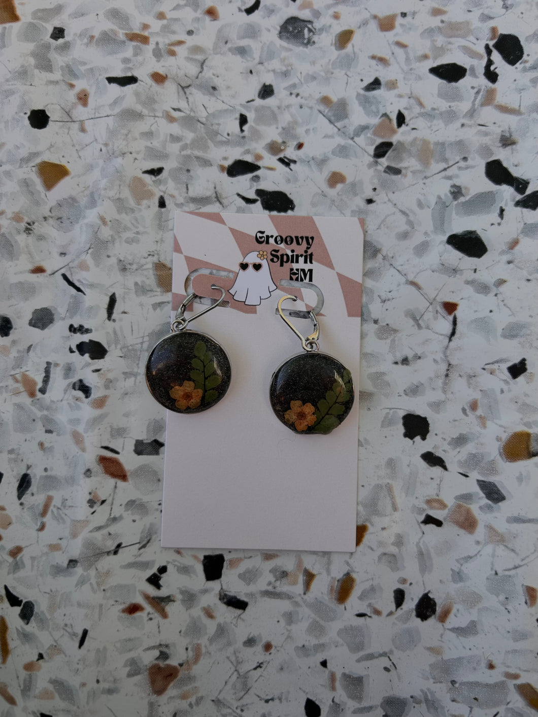 Black and orange shimmery floral huggie earrings